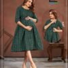 A mother wearing the Good NewwZ Full Flair Gown, showcasing its stylish design, adjustable back belt, and convenient side zips for breastfeeding.