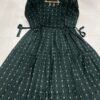A mother wearing the Good NewwZ Full Flair Gown, showcasing its stylish design, adjustable back belt, and convenient side zips for breastfeeding.