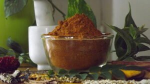 Dharwad Style Homemade Huli Pudi sambar powder with whole spices in background