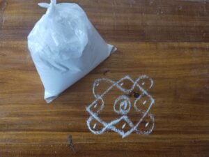 Brightly colored Rangoli Powder arranged in bowls for festive decoration