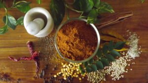 Dharwad Style Homemade Sarina Pudi (Sambar Powder) in a bowl with whole spices
